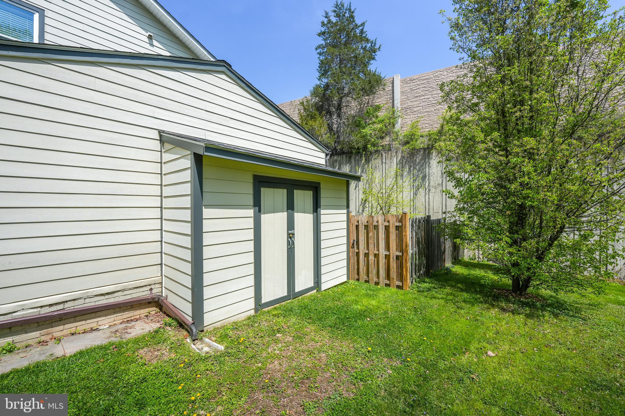 6930 27th Road North Arlington, VA 22213 - Photo 51 of 51 a view of a white house with a small yard and a large tree
