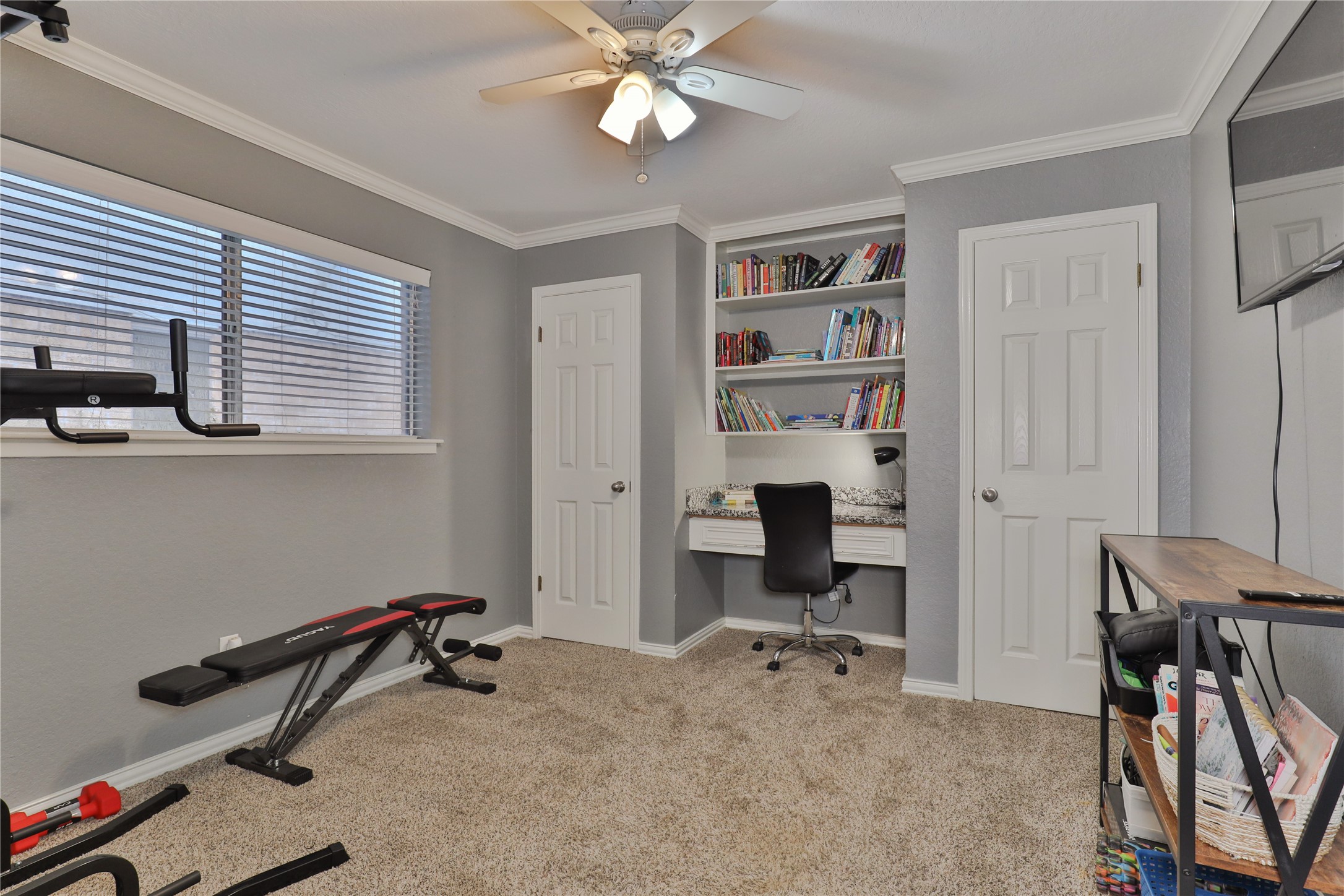 1 Shallowbrook Street Angleton, TX 77515 - Photo 19 of 30 a view of a workspace with furniture and a window