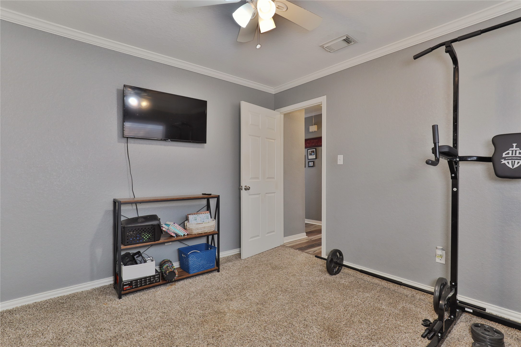 1 Shallowbrook Street Angleton, TX 77515 - Photo 20 of 30 a living room with a flat screen tv and a ceiling fan