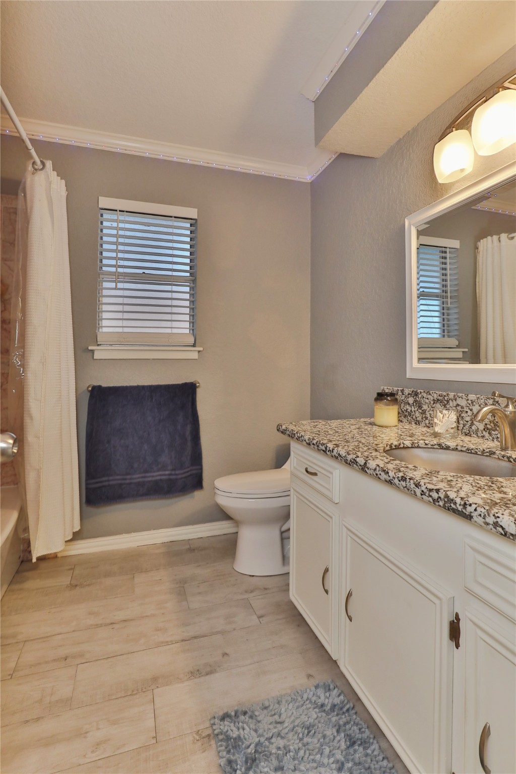 1 Shallowbrook Street Angleton, TX 77515 - Photo 21 of 30 a bathroom with a granite countertop sink a toilet a mirror and vanity