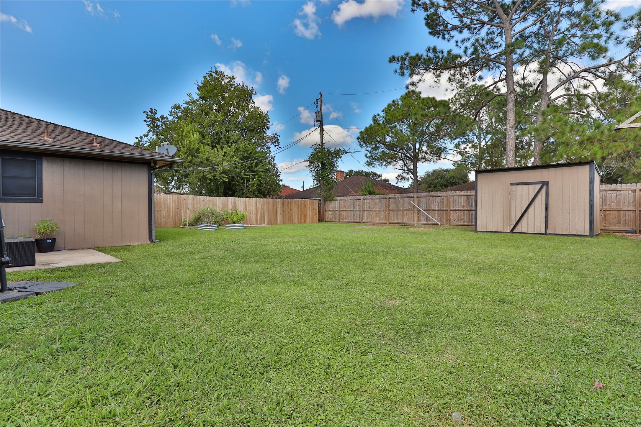 1 Shallowbrook Street Angleton, TX 77515 - Photo 27 of 30 a view of backyard with table and chairs and potted plants