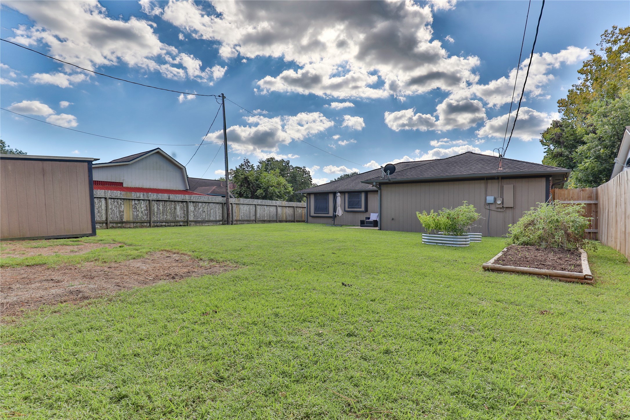 1 Shallowbrook Street Angleton, TX 77515 - Photo 29 of 30 a view of an house with backyard and a tree