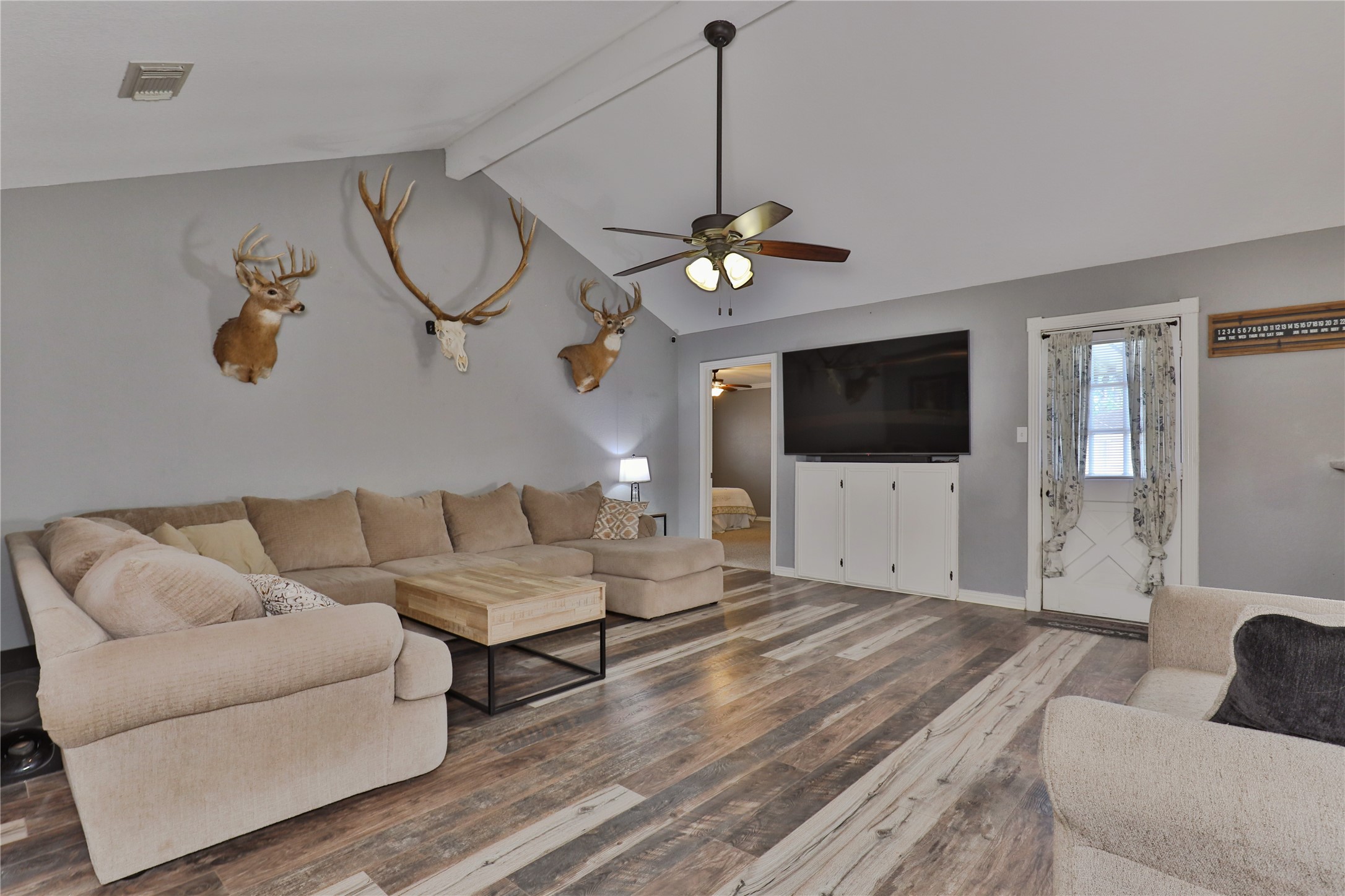 1 Shallowbrook Street Angleton, TX 77515 - Photo 7 of 30 a living room with furniture a flat screen tv and kitchen view