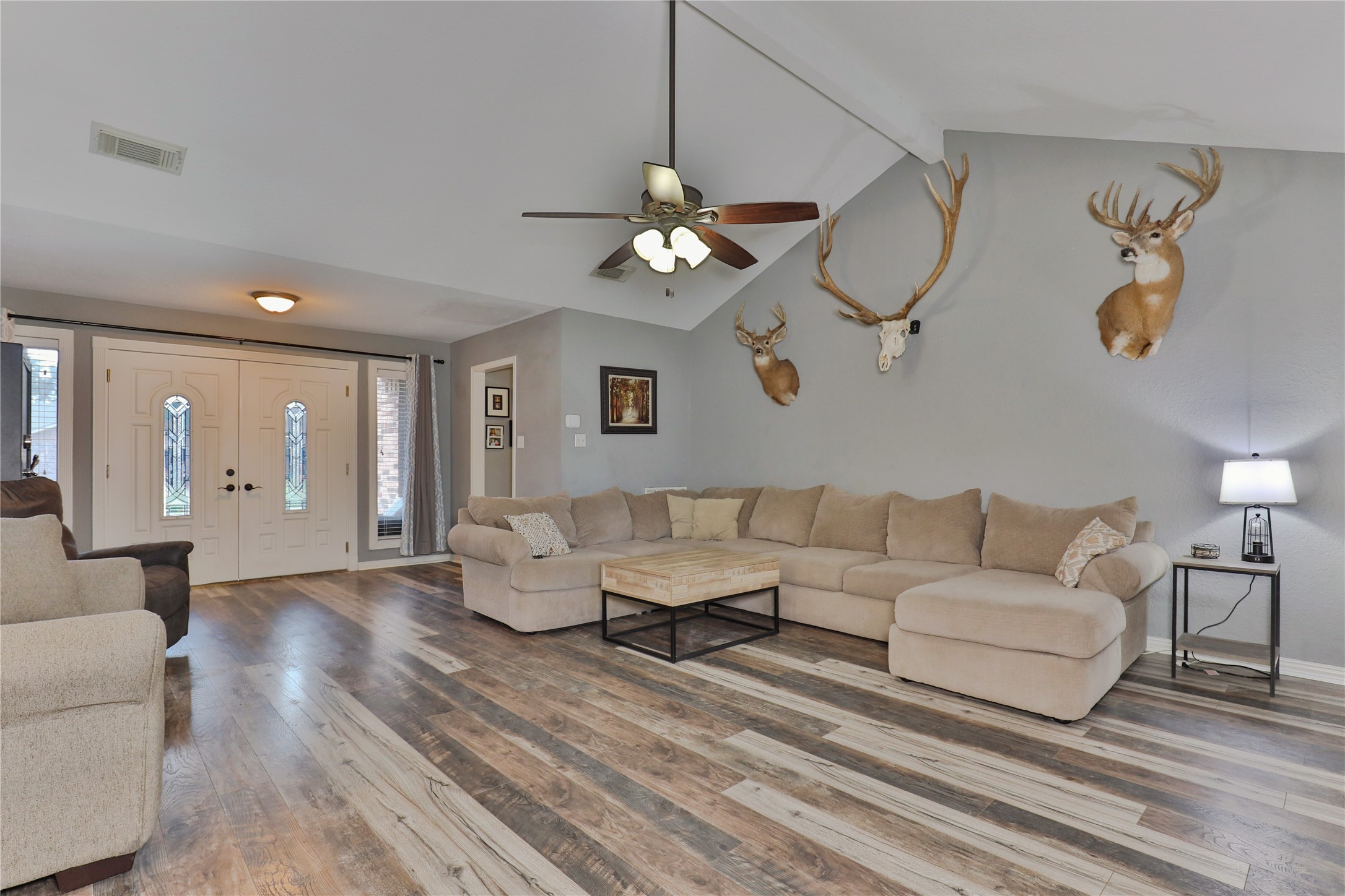 1 Shallowbrook Street Angleton, TX 77515 - Photo 9 of 30 a living room with couches chandelier and a dining table with wooden floor
