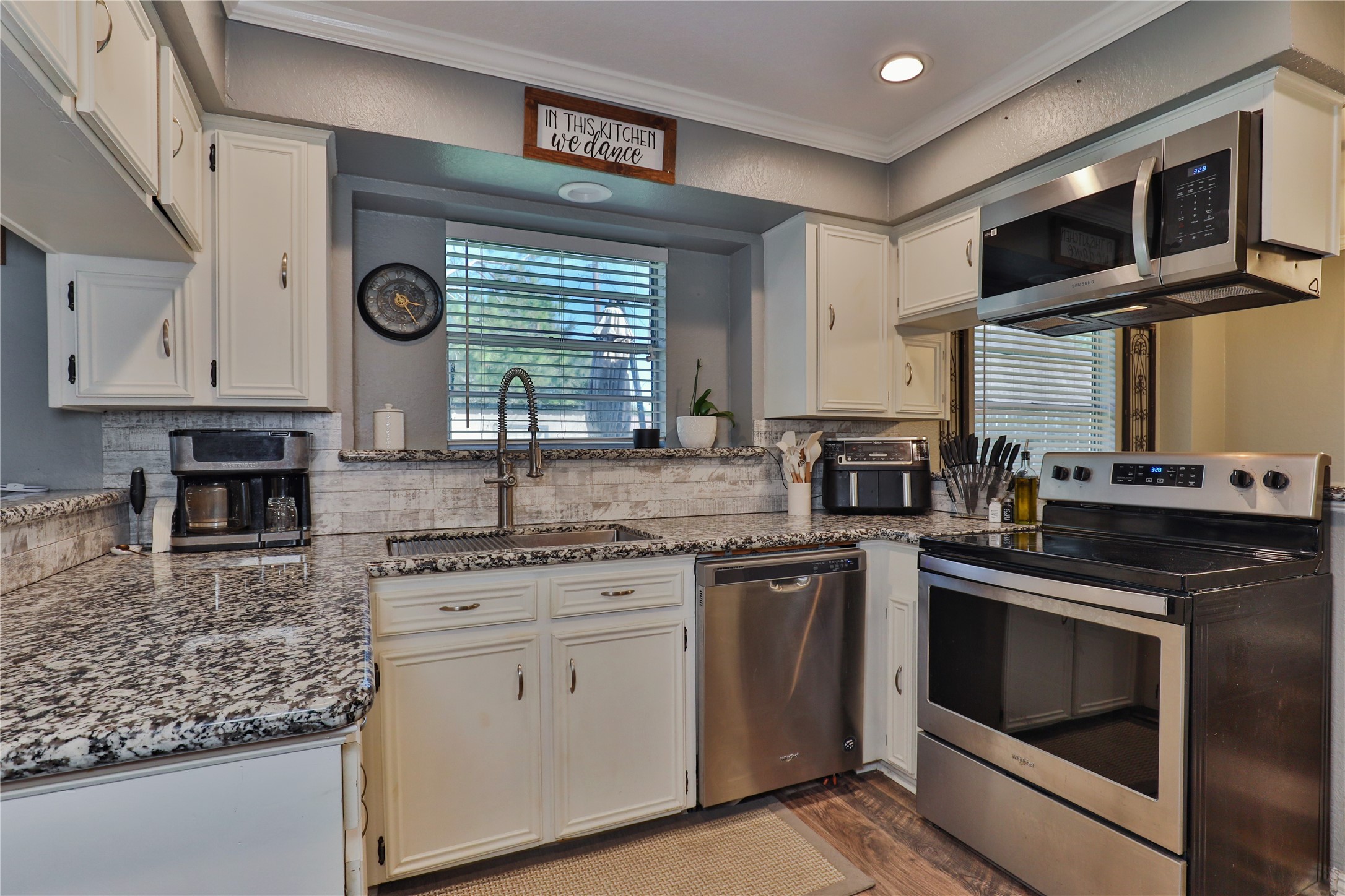 1 Shallowbrook Street Angleton, TX 77515 - Photo 10 of 30 a kitchen with granite countertop stainless steel appliances white cabinets granite counter tops and a window