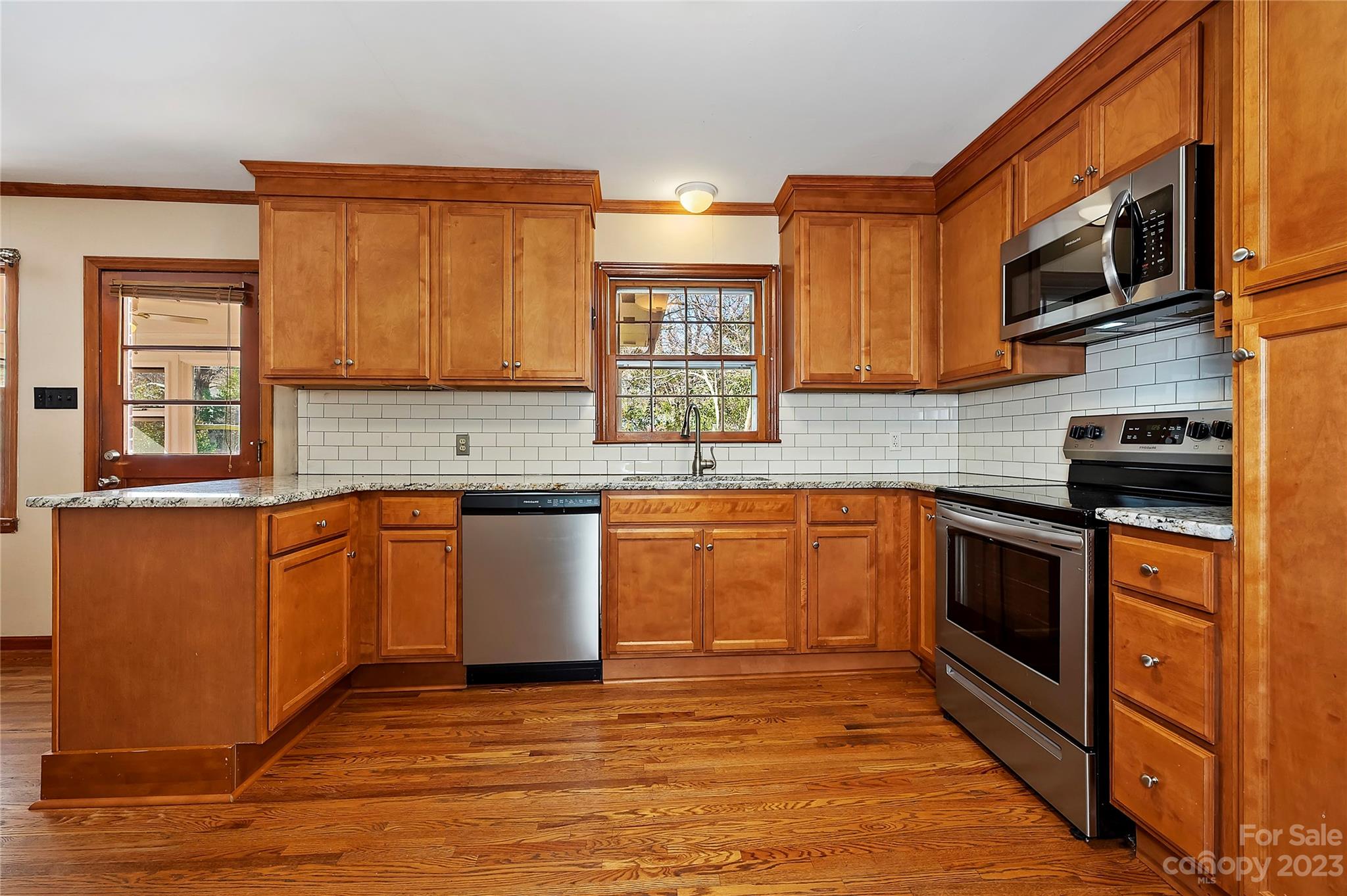 4200 Murrayhill Road Charlotte, NC 28209 - Photo 14 of 29 a kitchen with stainless steel appliances granite countertop a stove a sink and a microwave