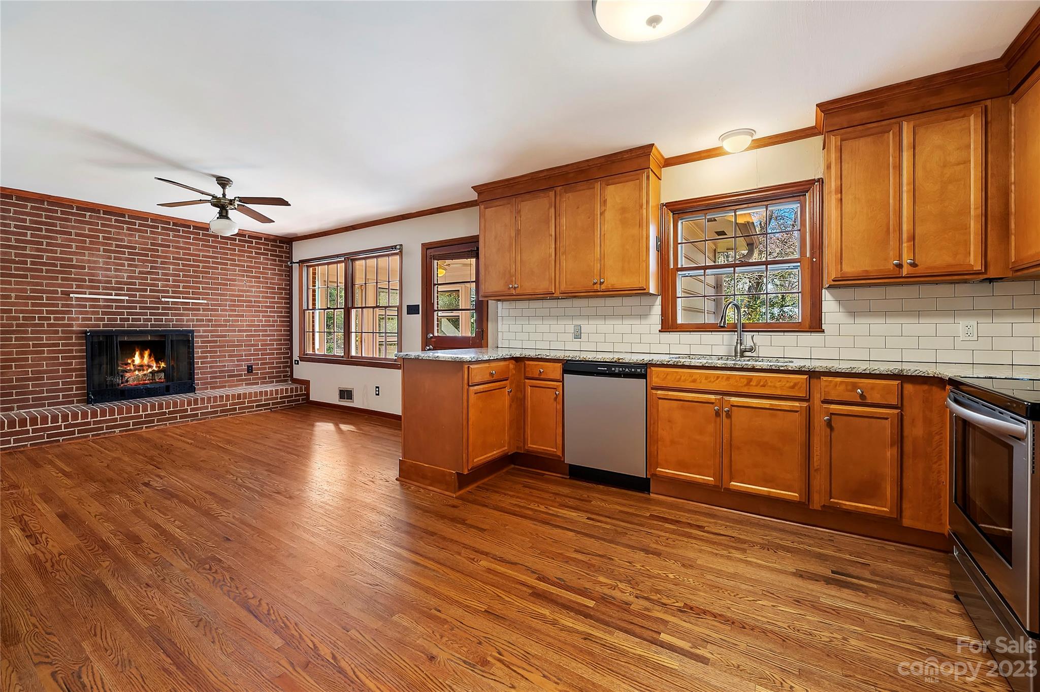 4200 Murrayhill Road Charlotte, NC 28209 - Photo 8 of 29 a kitchen with stainless steel appliances granite countertop a sink cabinets and wooden floor