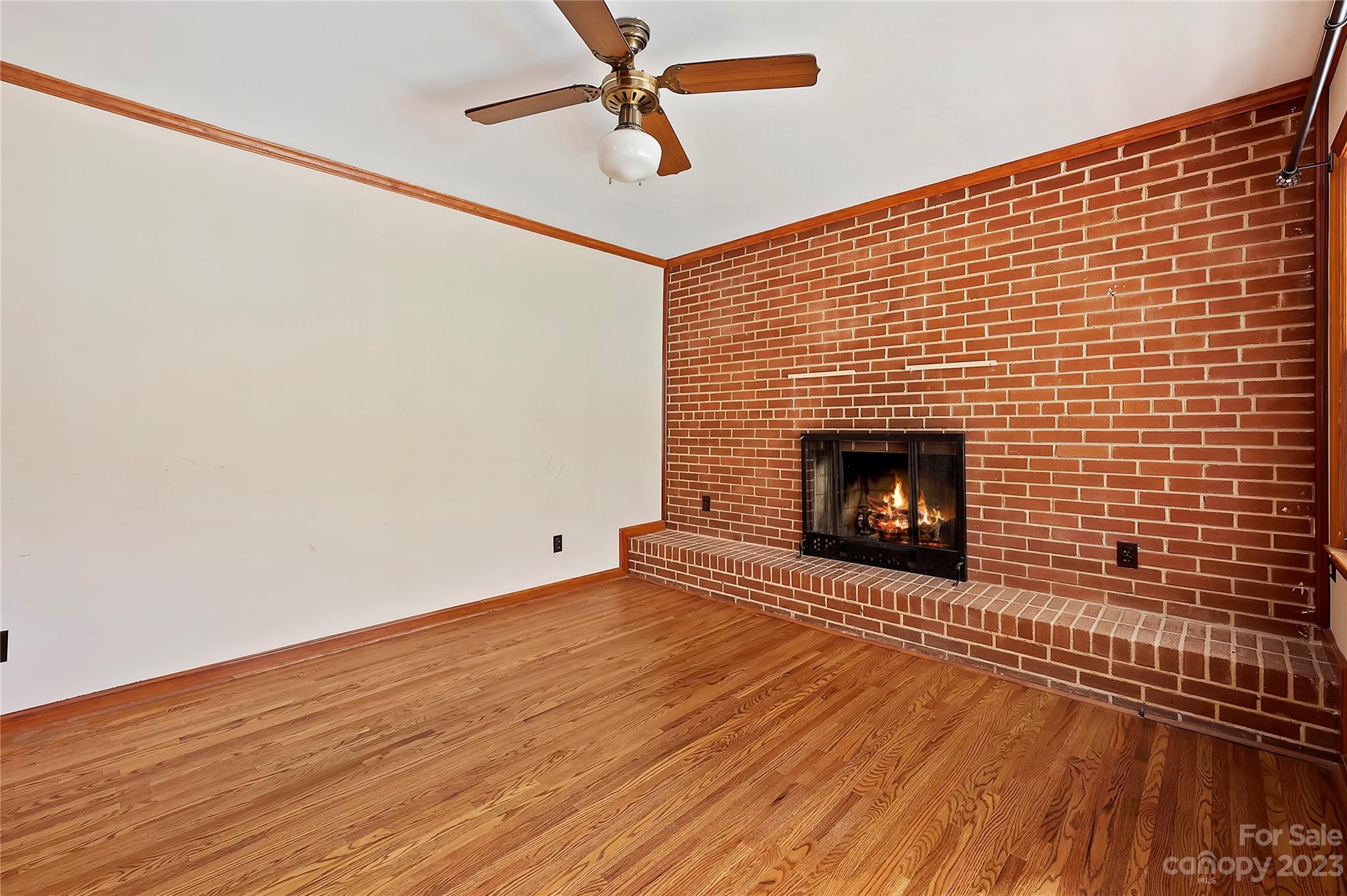 4200 Murrayhill Road Charlotte, NC 28209 - Photo 10 of 29 a view of an empty room with wooden floor and a fireplace