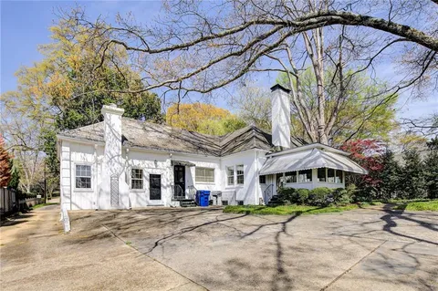 a view of a house with a yard and sitting area