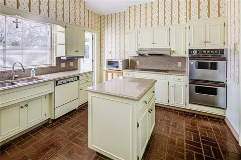 a kitchen with stainless steel appliances a stove sink and cabinets