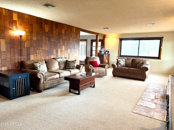a view of a room with wooden floor and a porch