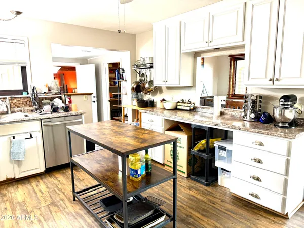 a bathroom with a sink a toilet and a window