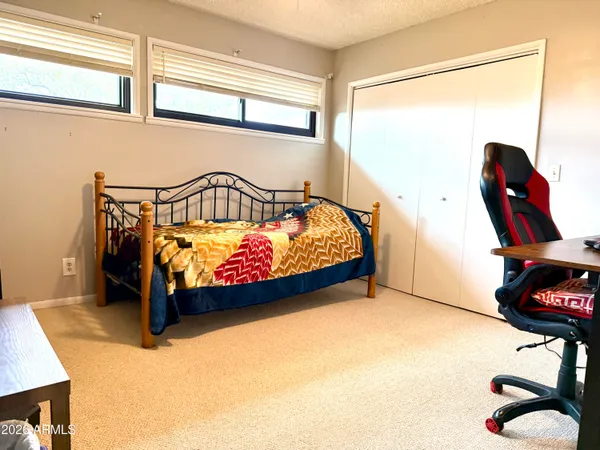 a living room with furniture a flat screen tv and a large window