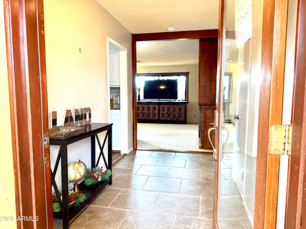 a kitchen with stainless steel appliances granite countertop a stove refrigerator and a refrigerator with wooden floor