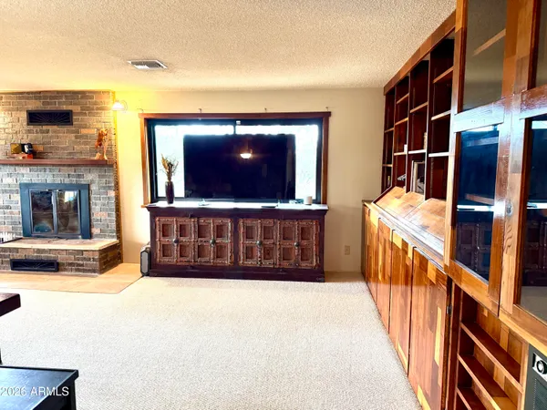 a kitchen with stainless steel appliances granite countertop a refrigerator a stove a sink dishwasher a dining table and chairs with wooden floor