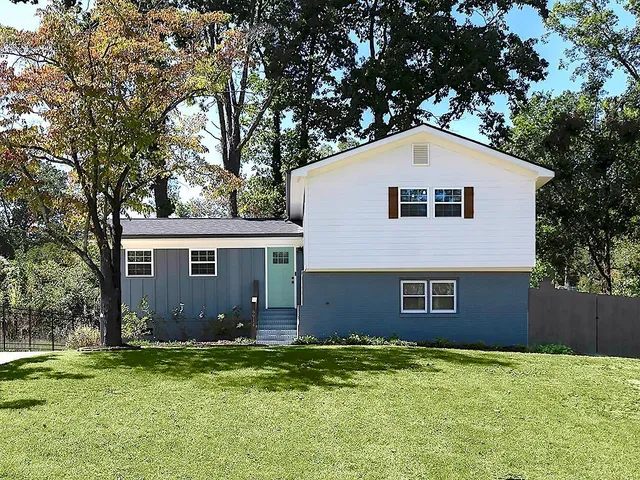 a front view of a house with a garden