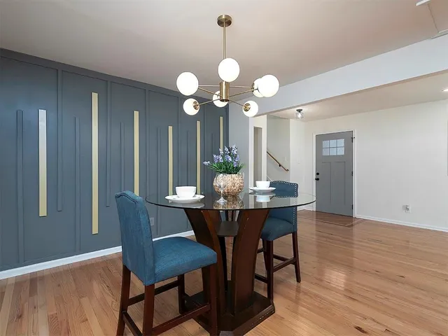 a view of a dining room with a table and chairs