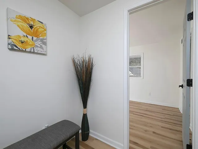 a view of a workspace with furniture and wooden floor
