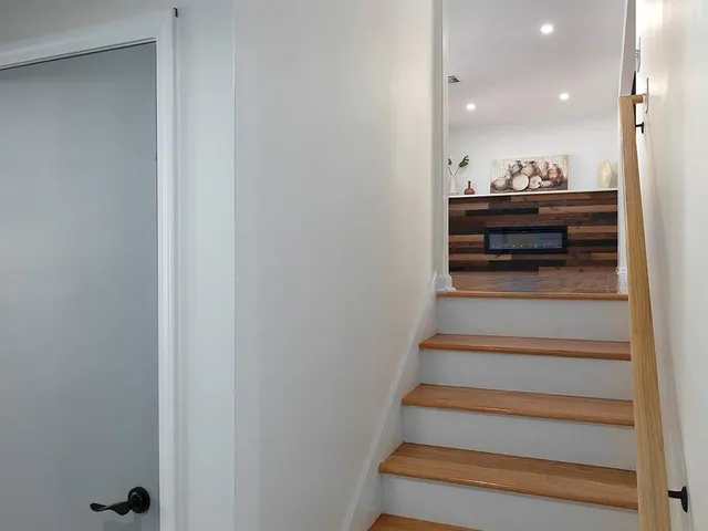 a view of entryway and hall with wooden floor