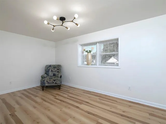 a room with wooden floor and a window
