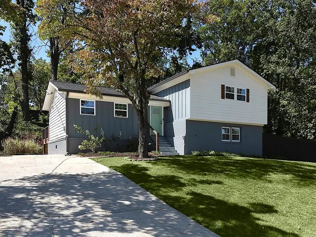 a front view of house with yard and trees