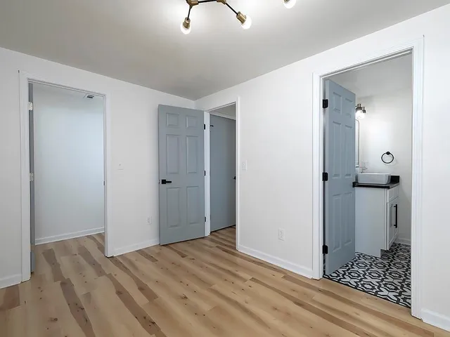 a view of a room with wooden floor and bathroom