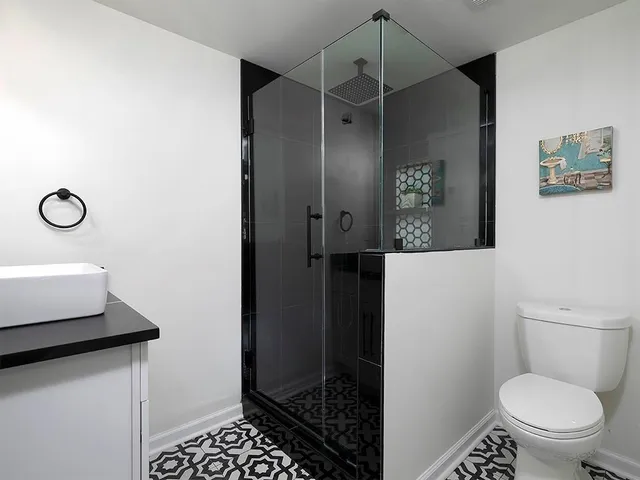 a bathroom with a toilet and a shower