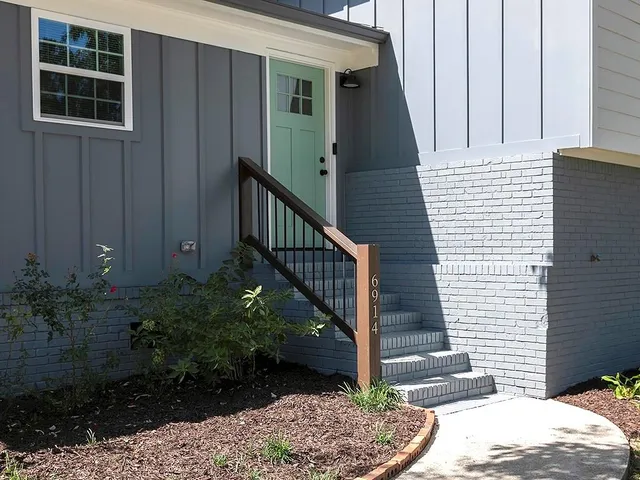 a view of a house with a potted plant and stairs