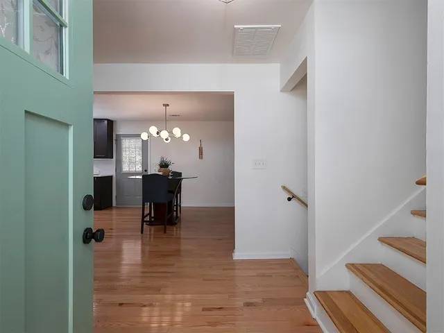a view of a livingroom with furniture and hardwood floor