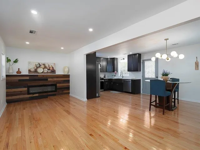 a view of kitchen and living room with wooden floor