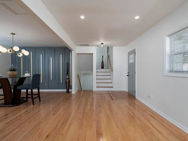 a view of a room with wooden floor and stairs