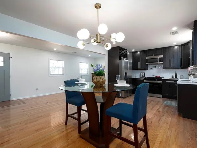 a view of a dining room with furniture and wooden floor