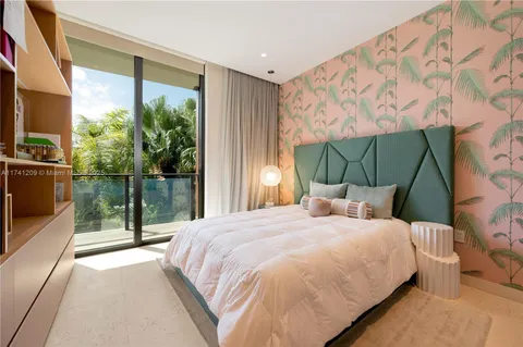 a bedroom with a bed and a view of balcony