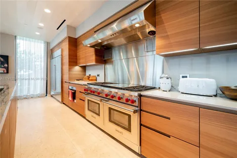 a kitchen with stainless steel appliances granite countertop a stove and a sink