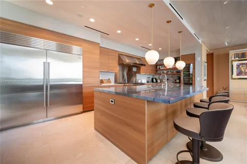 a kitchen with granite countertop a table and chairs in it