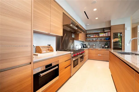 a kitchen with stainless steel appliances granite countertop a sink and a wooden floors