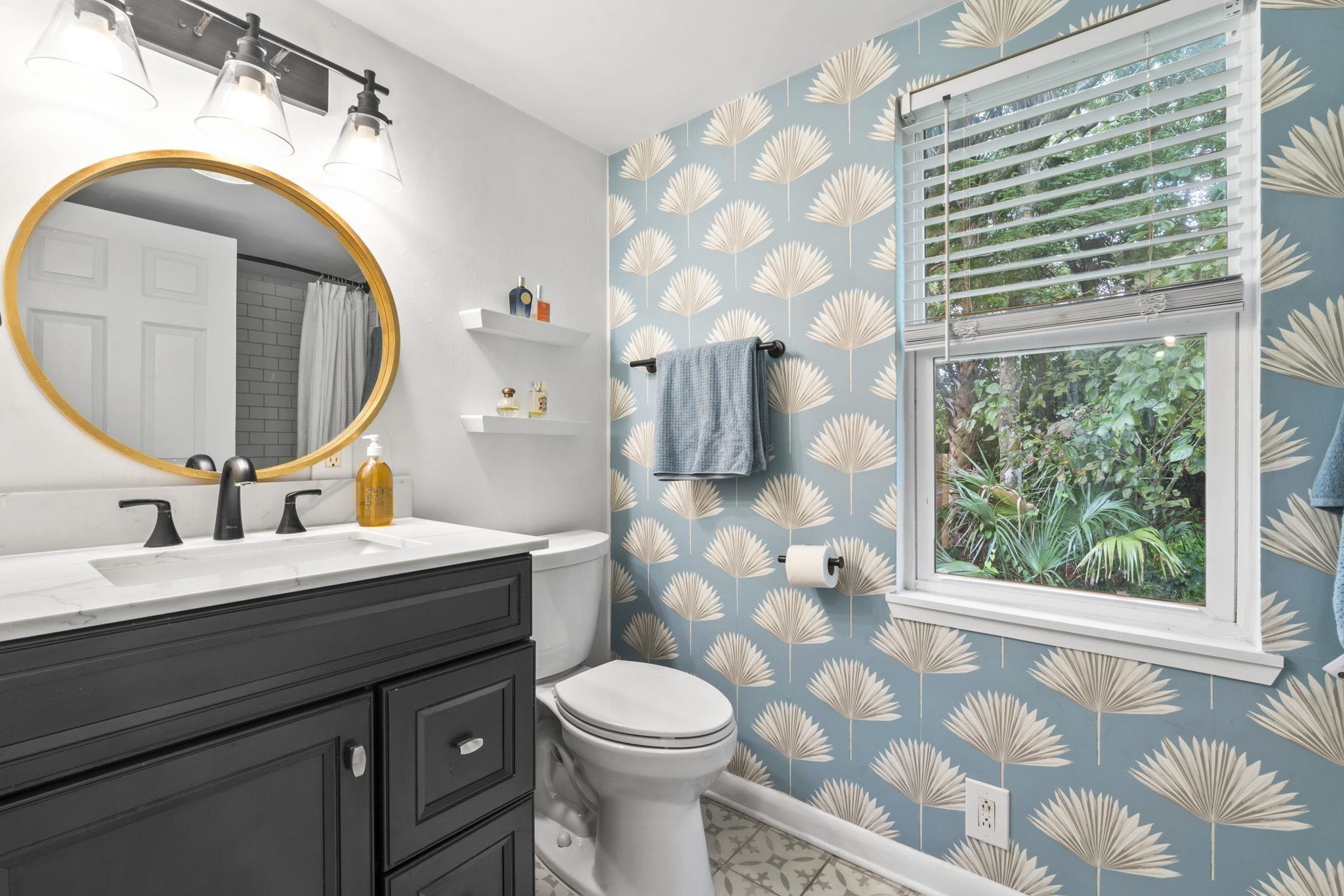 635 Madeore Street St. Augustine, FL 32084 - Photo 18 of 44 a bathroom with a sink a toilet and a mirror