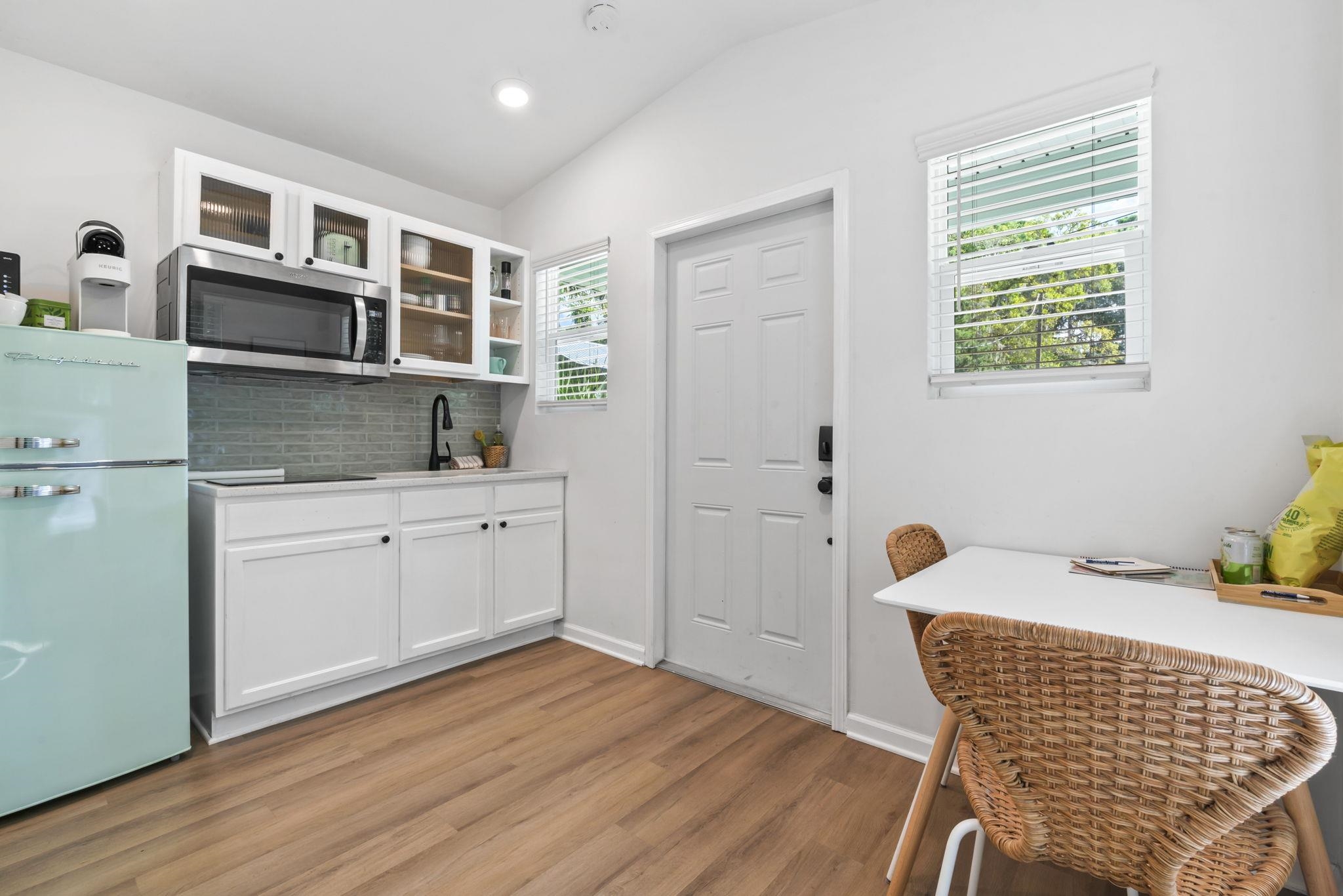 635 Madeore Street St. Augustine, FL 32084 - Photo 26 of 44 a kitchen with stainless steel appliances kitchen island wooden floors and center island