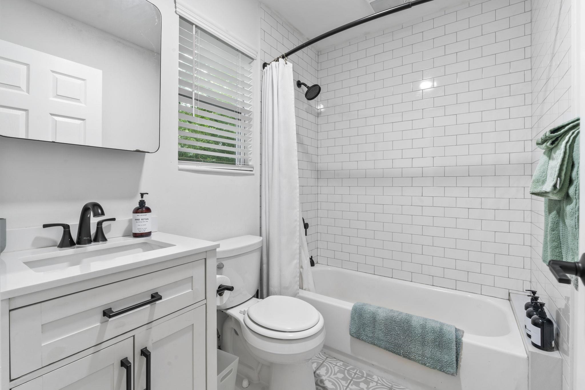 635 Madeore Street St. Augustine, FL 32084 - Photo 29 of 44 a bathroom with a sink a toilet and shower