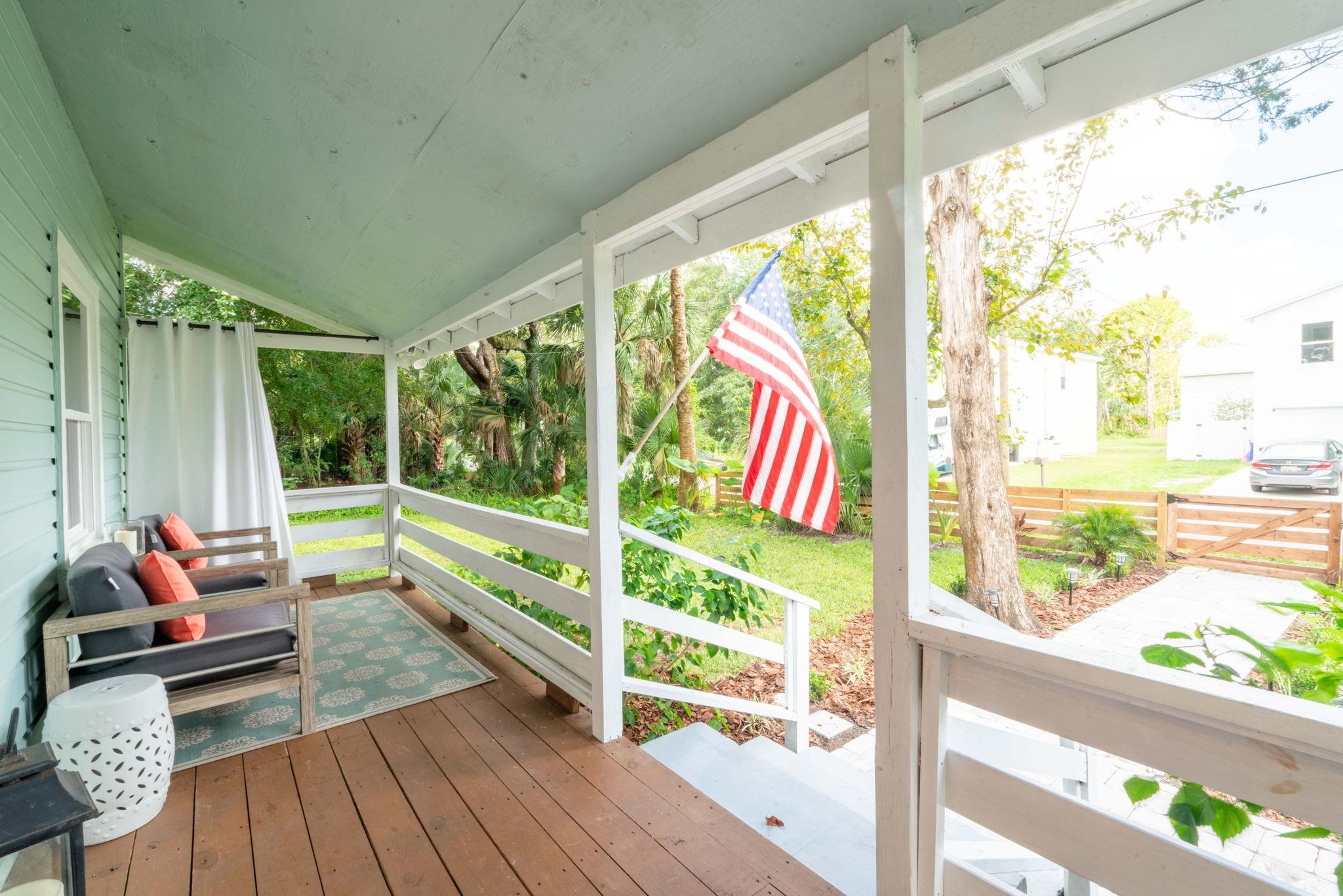 635 Madeore Street St. Augustine, FL 32084 - Photo 6 of 44 a living room with large windows and wooden floor