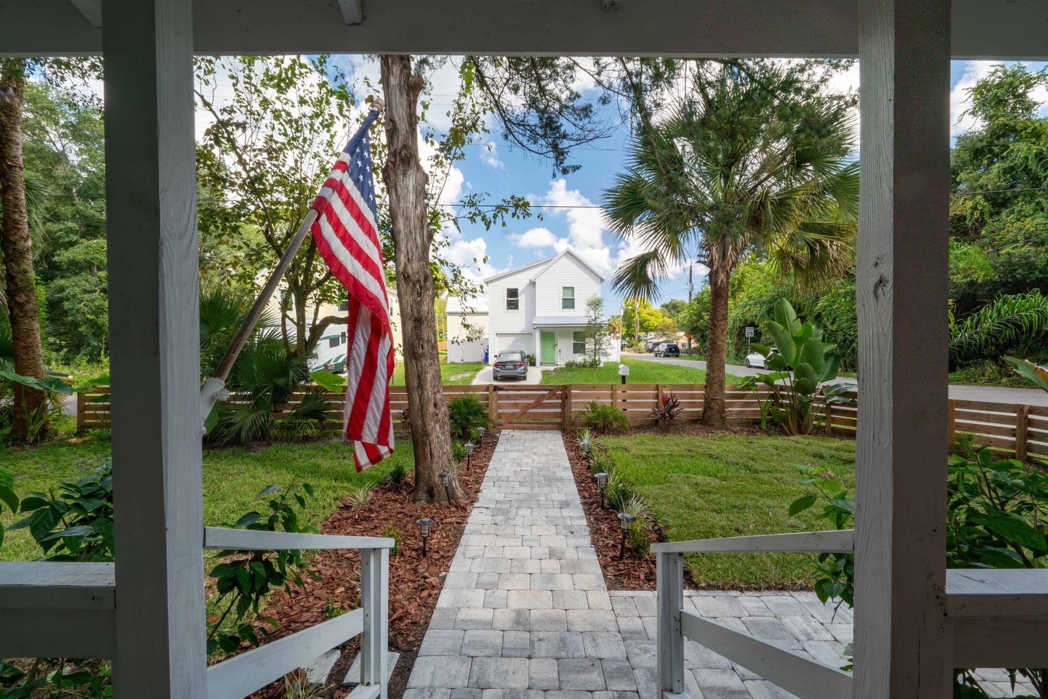 635 Madeore Street St. Augustine, FL 32084 - Photo 7 of 44 a view of pathway with a big yard and potted plants