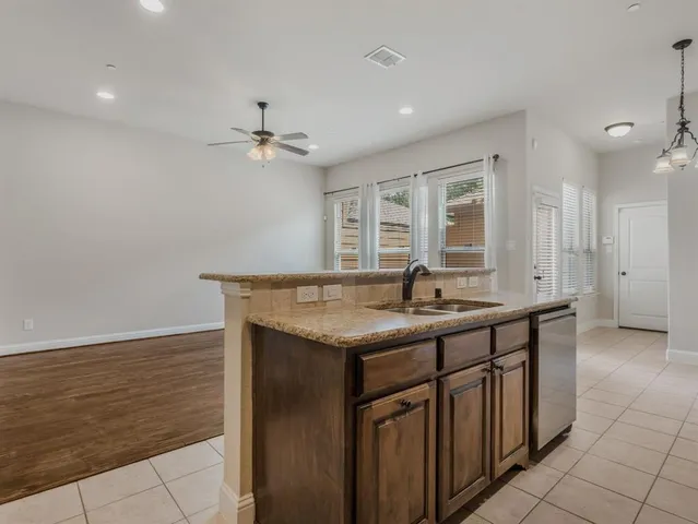 a bathroom with a granite countertop toilet a sink and a mirror