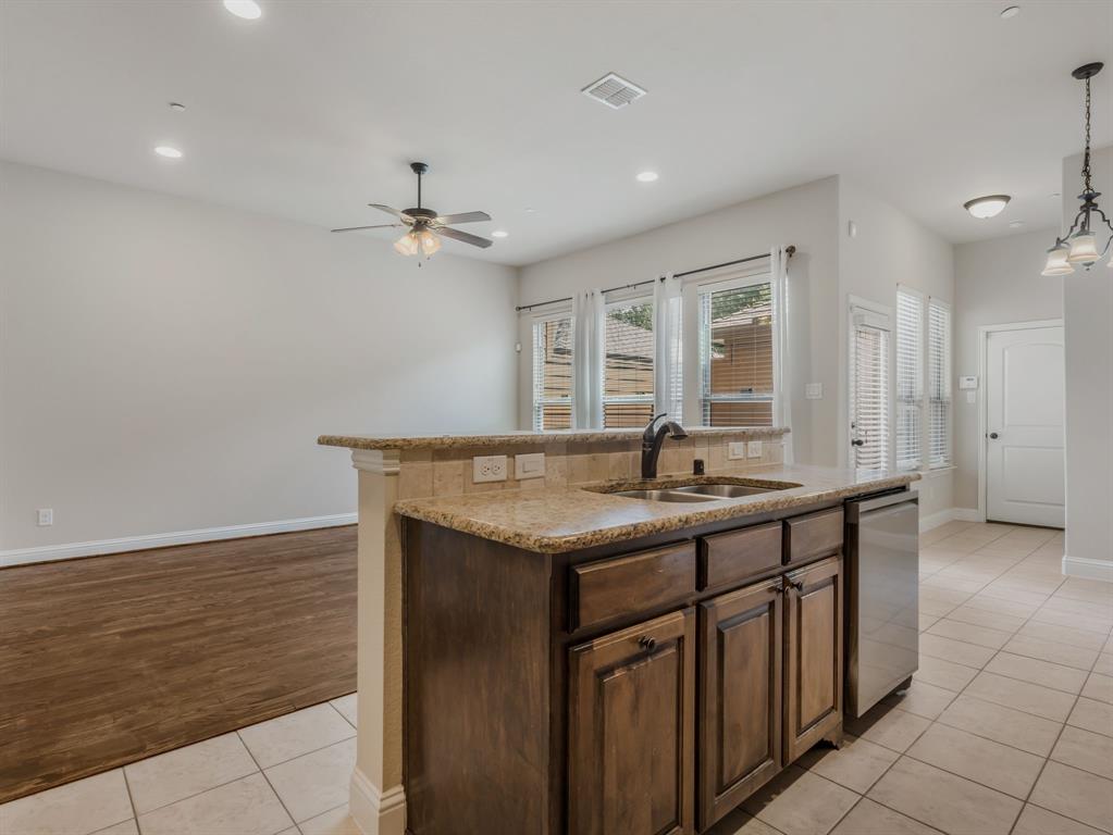 4672 Cecile Road Plano, TX 75024 - Photo 18 of 31 a kitchen with granite countertop a sink and a stove