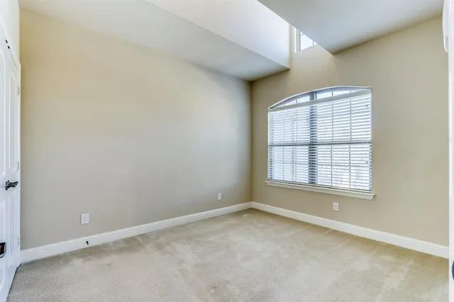 a bathroom with a granite countertop bathtub shower sink vanity mirror and toilet
