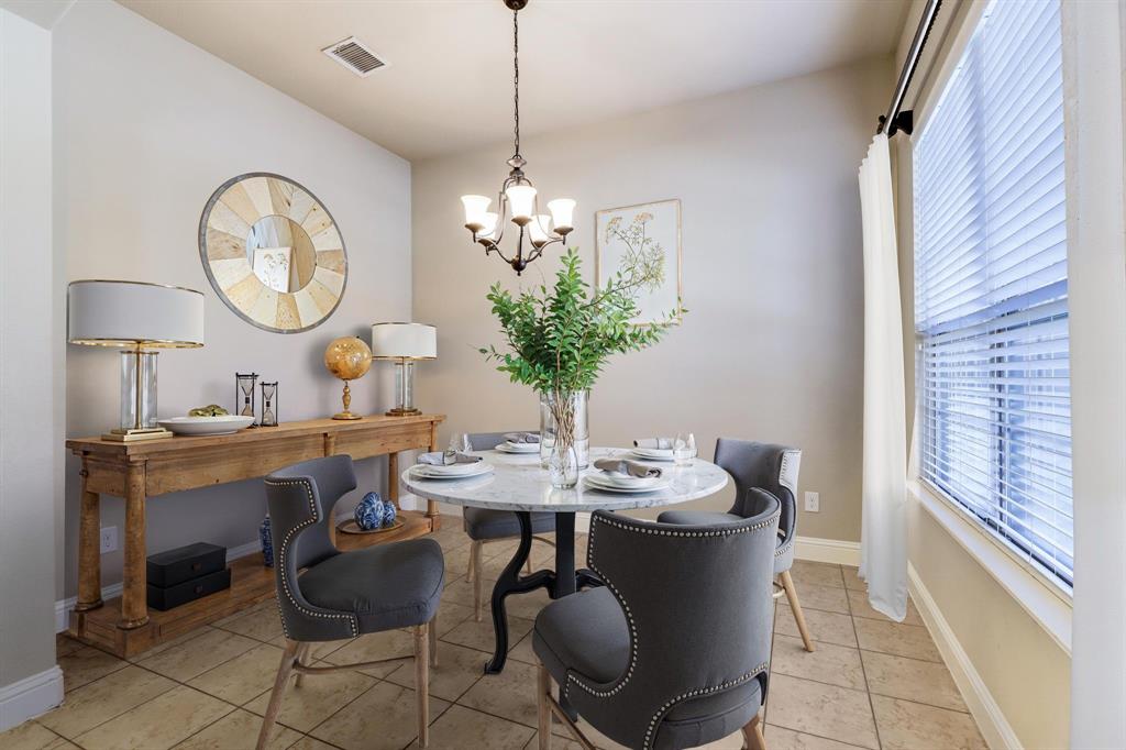 4672 Cecile Road Plano, TX 75024 - Photo 7 of 31 a dining room with wooden floor a chandelier a wooden table and chairs