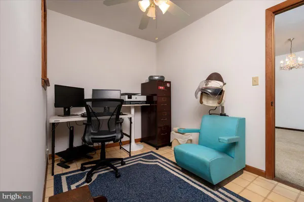 a livingroom with workspace and a couch