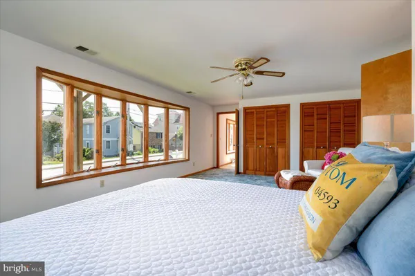 a bedroom with a large bed and a large window