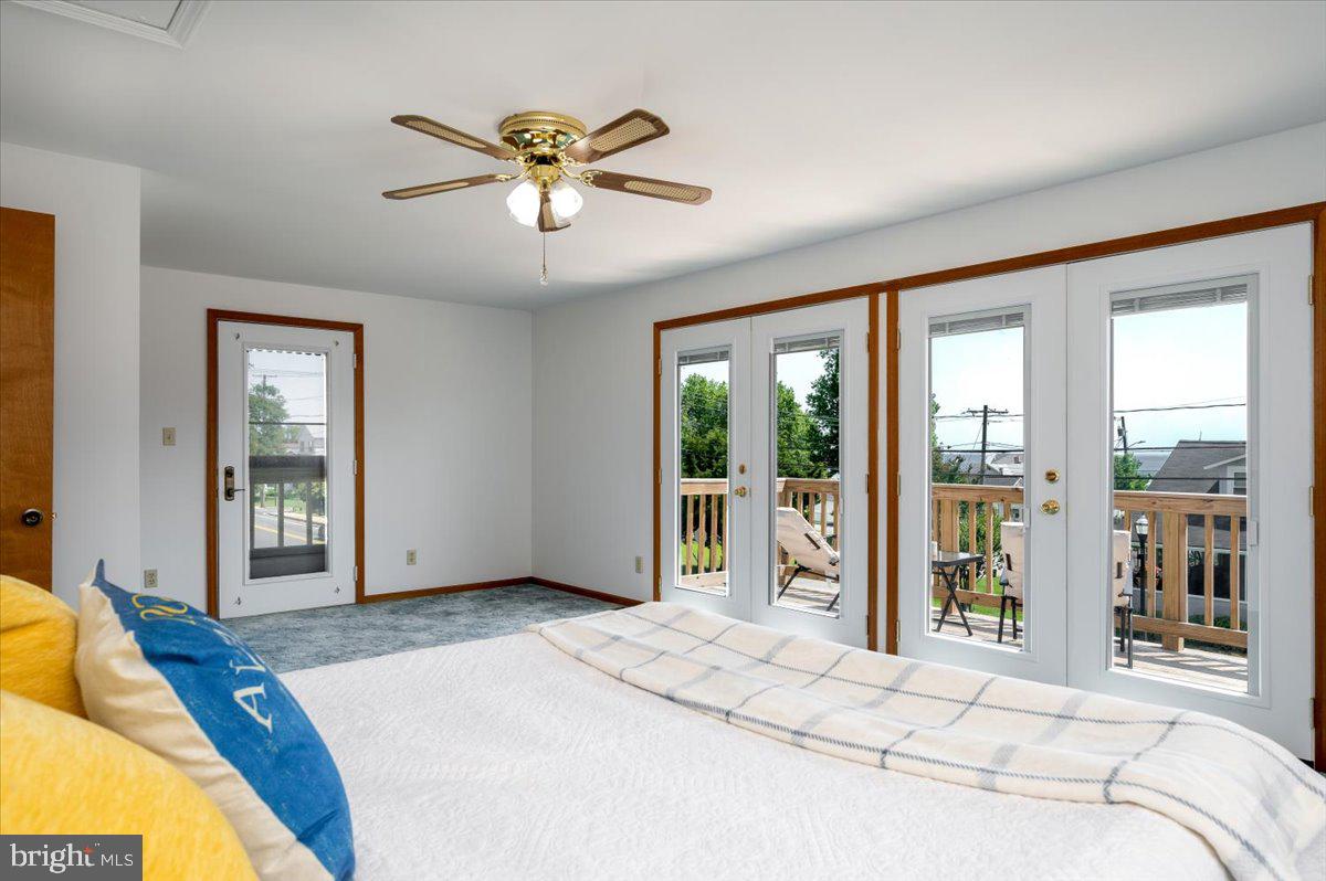 8236 Bayside Road Chesapeake Beach, MD 20732 - Photo 23 of 39 a bedroom with a large bed and a large window