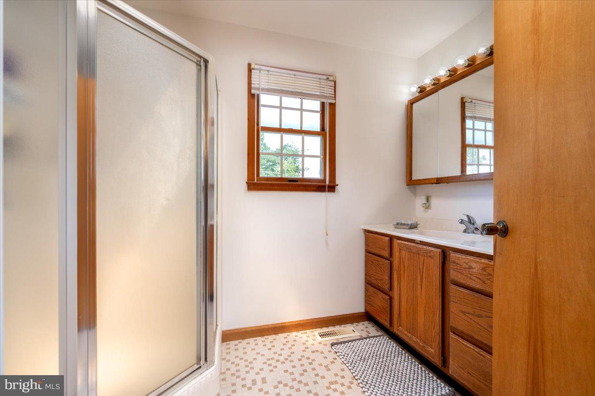 8236 Bayside Road Chesapeake Beach, MD 20732 - Photo 25 of 39 a bathroom with a sink and a mirror