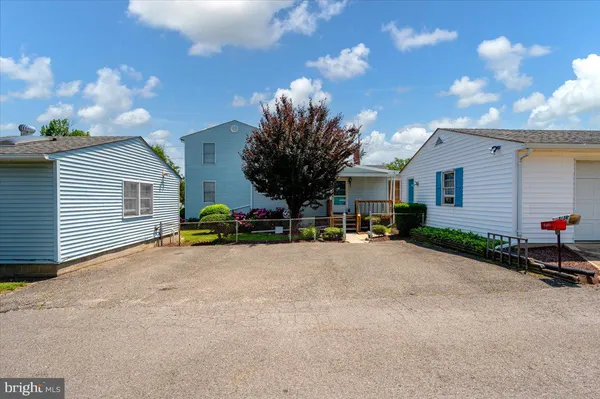 a view of a house with a patio and a yard